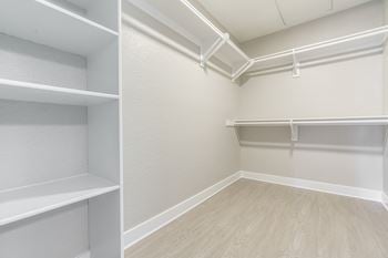 An empty room with shelves and a closet